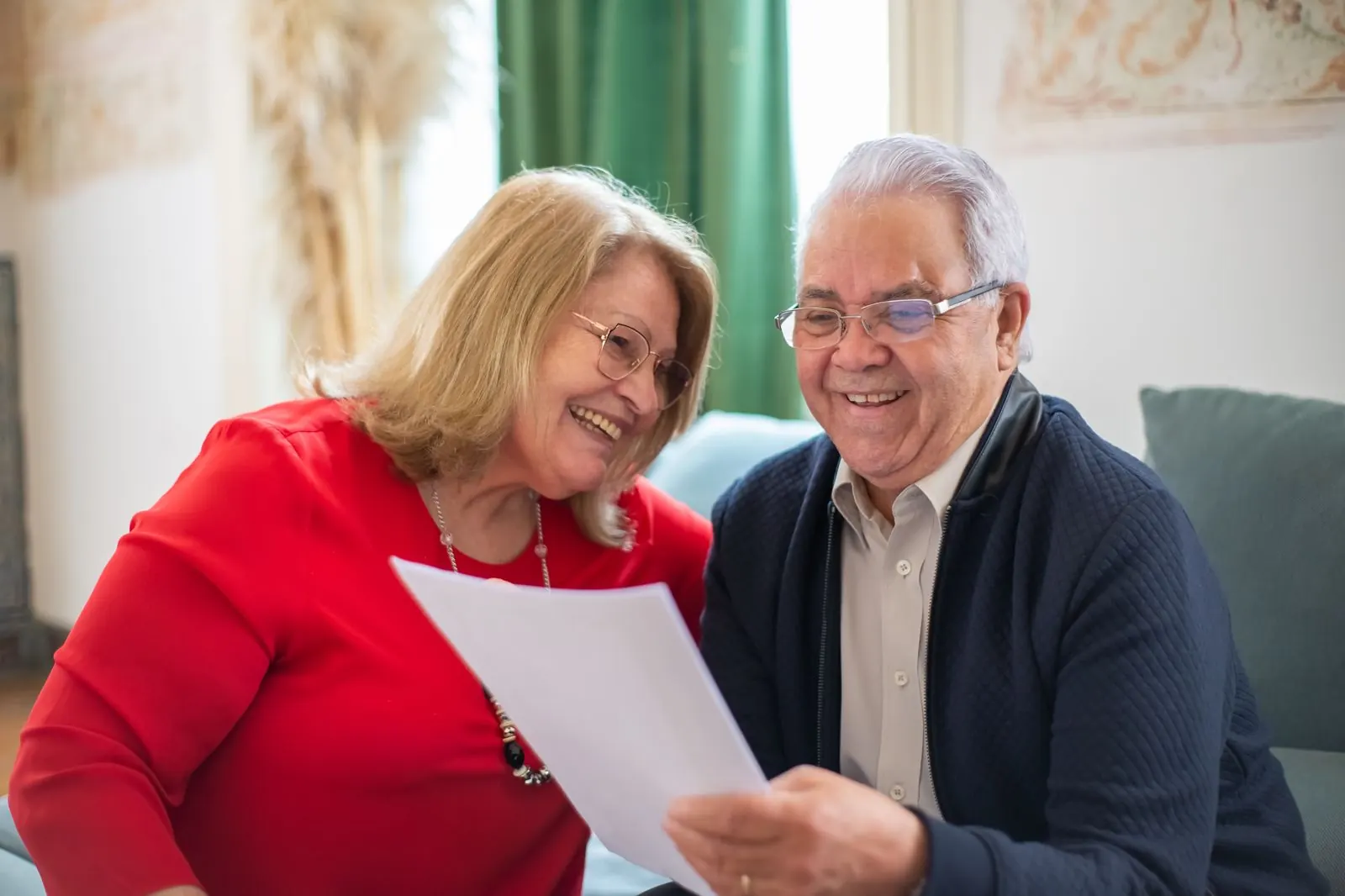 A couple on a sofa read their advice document together